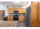 Kitchen featuring stainless steel appliances, granite countertops, and wood cabinetry at 28330 Peterson Camp Rd, Brooksville, FL 34601