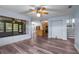 Bright living room showcasing an open floor plan, new floors, and access to kitchen and stairs at 28330 Peterson Camp Rd, Brooksville, FL 34601