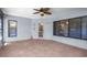 Enclosed patio with ceiling fan, door to outside, and large windows for lots of natural light at 28330 Peterson Camp Rd, Brooksville, FL 34601