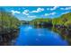 Stunning river view showing the water, trees, a few clouds and the bright blue sky at 28330 Peterson Camp Rd, Brooksville, FL 34601