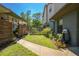 Side yard featuring a wooden fence, manicured lawn, and a pathway, adding a touch of privacy and charm at 28330 Peterson Camp Rd, Brooksville, FL 34601