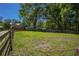 Expansive, fenced-in backyard featuring green grass and mature trees, ideal for outdoor activities and enjoying nature at 28330 Peterson Camp Rd, Brooksville, FL 34601