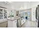 Bright kitchen featuring stainless steel appliances, a kitchen island, and views of the water at 3009 7Th Avenue E Cir, Bradenton, FL 34208