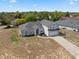 Aerial view of a charming two-story home with mature landscaping, nestled in a residential neighborhood at 3017 Aldoro Ave, Spring Hill, FL 34609