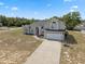 Aerial shot of a two-story house with mature trees and landscaping at 3017 Aldoro Ave, Spring Hill, FL 34609