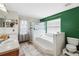Bathroom featuring a soaking tub with tiled backsplash and walk-in shower at 3017 Aldoro Ave, Spring Hill, FL 34609