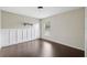 Bedroom features wood-look flooring, wainscoting, and a window at 3017 Aldoro Ave, Spring Hill, FL 34609