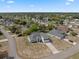 Elevated view of a two-story home with a red door, well-kept lawn, and a peaceful neighborhood setting at 3017 Aldoro Ave, Spring Hill, FL 34609