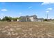 Wide angle front exterior view of a two-story home and expansive lawn at 3017 Aldoro Ave, Spring Hill, FL 34609