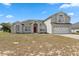 Charming two-story home featuring a well-maintained lawn, two-car garage, and a welcoming red front door at 3017 Aldoro Ave, Spring Hill, FL 34609