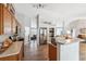 Open kitchen with wood cabinets, stainless steel appliances, and an eat-in breakfast bar at 3017 Aldoro Ave, Spring Hill, FL 34609
