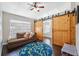 Comfortable living room with wood look floors, a cozy couch, and stylish barn doors at 3017 Aldoro Ave, Spring Hill, FL 34609