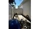 Narrow backyard with white fence, brick path, and outdoor equipment at 3037 Leroy W St, Tampa, FL 33607