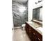 Beautiful bathroom with a marble tile shower, double sink vanity, and modern lighting at 3037 Leroy W St, Tampa, FL 33607