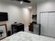 Cozy bedroom with a kitchenette featuring a mini fridge, microwave, and dining table at 3037 Leroy W St, Tampa, FL 33607