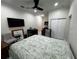 Charming bedroom including a kitchenette, table, and large-screen TV, with ample closet space at 3037 Leroy W St, Tampa, FL 33607