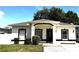 Charming single-story home featuring a tidy front lawn, black trim and a welcoming entrance at 3037 Leroy W St, Tampa, FL 33607