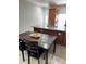 Kitchen area featuring a dining table and granite countertop island with a stainless steel sink at 3037 Leroy W St, Tampa, FL 33607