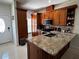 Lovely kitchen with wooden cabinets, a granite countertop island, and stainless steel appliances at 3037 Leroy W St, Tampa, FL 33607