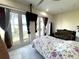 Bright main bedroom with a floral patterned bedspread, marble floors and French doors at 3037 Leroy W St, Tampa, FL 33607