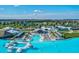 Stunning aerial view of the community pool, featuring a swim-up bar, cabanas, and lounge chairs at 30839 Penny Surf Loop, Wesley Chapel, FL 33545
