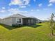 Lush backyard featuring a screened lanai, ideal for relaxation and entertaining guests at 30839 Penny Surf Loop, Wesley Chapel, FL 33545