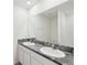 Bathroom featuring double sink vanity with stylish dark gray and white patterned countertop at 30839 Penny Surf Loop, Wesley Chapel, FL 33545