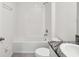 Bright bathroom showcasing a tiled shower and tub combo with white fixtures at 30839 Penny Surf Loop, Wesley Chapel, FL 33545