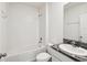Bright bathroom showcasing a tiled shower and tub combo with white fixtures at 30839 Penny Surf Loop, Wesley Chapel, FL 33545