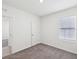 Bedroom featuring neutral carpet, natural light, and a door to an additional room at 30839 Penny Surf Loop, Wesley Chapel, FL 33545