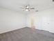 Bedroom with carpet, ceiling fan, and a door to an attached bathroom at 30839 Penny Surf Loop, Wesley Chapel, FL 33545