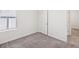 Empty bedroom features gray carpet and white walls at 30839 Penny Surf Loop, Wesley Chapel, FL 33545