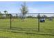 Fenced community dog park with play equipment and shaded gazebo offers residents a great place to exercise their pets at 30839 Penny Surf Loop, Wesley Chapel, FL 33545