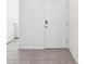 Bright entryway with neutral tile flooring leading to a white front door at 30839 Penny Surf Loop, Wesley Chapel, FL 33545