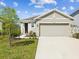 Charming single-Gathering home featuring a two-car garage, manicured landscaping, and a welcoming entrance at 30839 Penny Surf Loop, Wesley Chapel, FL 33545