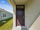 Close-up of the front door, showcasing the home's welcoming entry and curb appeal at 30839 Penny Surf Loop, Wesley Chapel, FL 33545