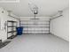 Spacious two car garage with sealed floor and storage shelving at 30839 Penny Surf Loop, Wesley Chapel, FL 33545
