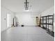 Spacious two car garage with sealed floor and storage shelving at 30839 Penny Surf Loop, Wesley Chapel, FL 33545