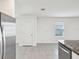 Bright kitchen showcasing neutral tile flooring and granite countertops with stainless steel appliances at 30839 Penny Surf Loop, Wesley Chapel, FL 33545