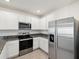 Bright kitchen with stainless steel appliances, granite countertops, and lots of cabinet storage at 30839 Penny Surf Loop, Wesley Chapel, FL 33545