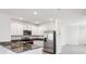 Open kitchen with stainless steel appliances, granite countertops, and a bright and spacious design at 30839 Penny Surf Loop, Wesley Chapel, FL 33545