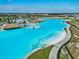 Stunning aerial view of the lagoon featuring a tiki bar and pristine turquoise water at 30839 Penny Surf Loop, Wesley Chapel, FL 33545