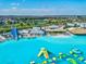 Expansive lagoon view with an inflatable water park and a towering water slide at 30839 Penny Surf Loop, Wesley Chapel, FL 33545