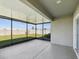 Screened lanai overlooking a manicured backyard with a view of the fence at 30839 Penny Surf Loop, Wesley Chapel, FL 33545