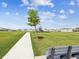 Neighborhood walking path and bench with green space and playground provides residents place to gather and enjoy time together at 30839 Penny Surf Loop, Wesley Chapel, FL 33545