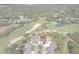 Aerial view showcasing the residential community, golf course, and nearby pond at 3160 Whispering Pines Ct, Spring Hill, FL 34606