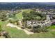 Beautiful aerial view of community on golf course with pond and green landscape at 3160 Whispering Pines Ct, Spring Hill, FL 34606