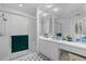 Bright bathroom with walk-in shower, white cabinets, and black and white checkered tile at 3160 Whispering Pines Ct, Spring Hill, FL 34606