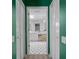 Bright bathroom with white cabinets, large mirror, and classic black and white checkered tile at 3160 Whispering Pines Ct, Spring Hill, FL 34606