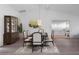 Bright dining room features elegant decor, a modern chandelier, and stylish flooring at 3160 Whispering Pines Ct, Spring Hill, FL 34606
